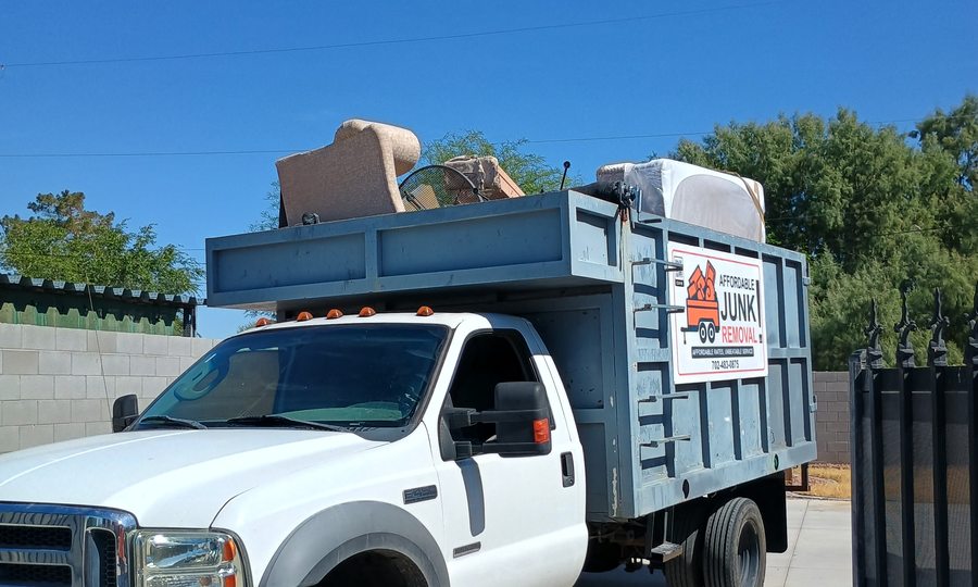 Affordable Junk Removal truck loaded with a couch and household items