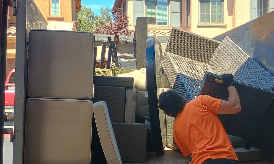 Mattresses and patio sets stacked on the truck bed